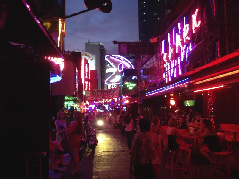 Neon go-go bar street at night on Soi Cowboy, Bangkok