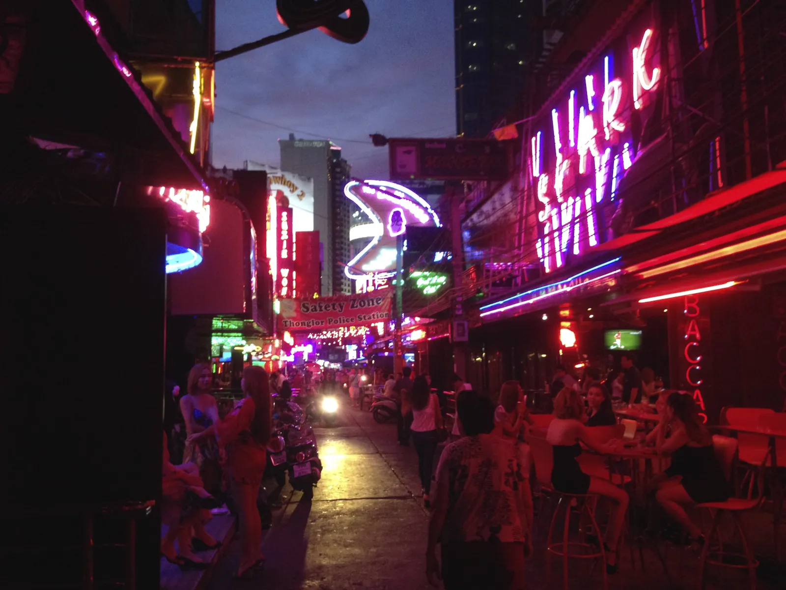 Neon go-go bar street at night on Soi Cowboy, Bangkok