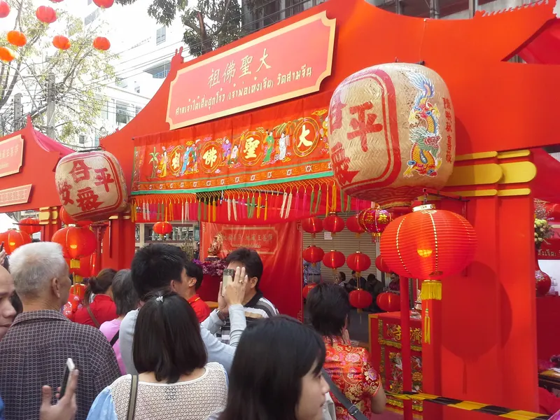 Red lanterns and crowds in Bangkok Chinatown for Chinese New Year