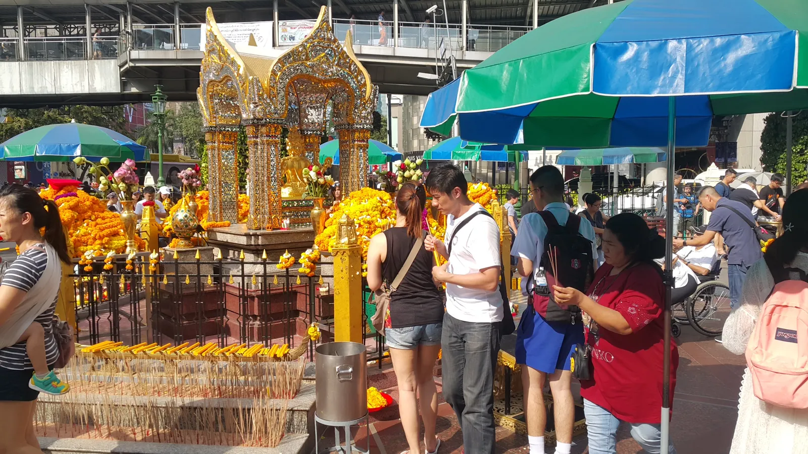 Flower garlands and worshippers at the Erawan Shrine in Bangkok
