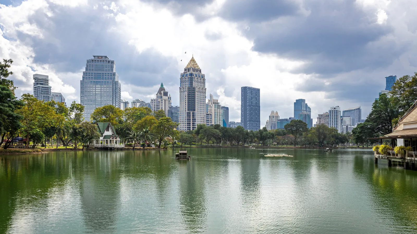 Lumphini Park lake with Bangkok towers behind it