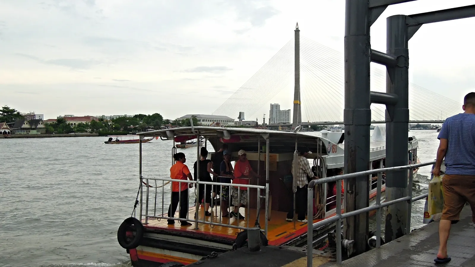 Passengers waiting at a Chao Phraya river pier