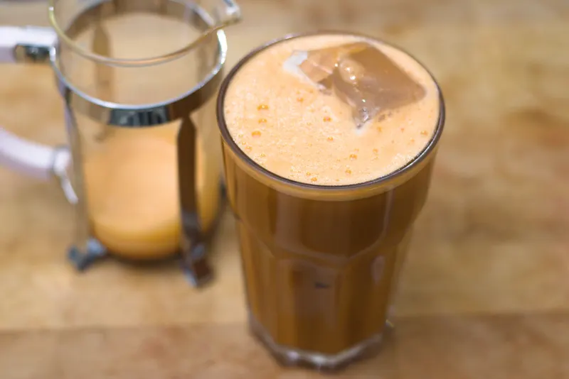 Thai iced tea and coffee on a café table in Bangkok